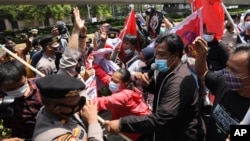 Activists scuffle with police officers as they are dispersed during a rally against Myanmar's military coup near the Association of Southeast Asian Nations (ASEAN) Secretariat ahead of a leaders' meeting in Jakarta, Indonesia, Saturday, April 24,…