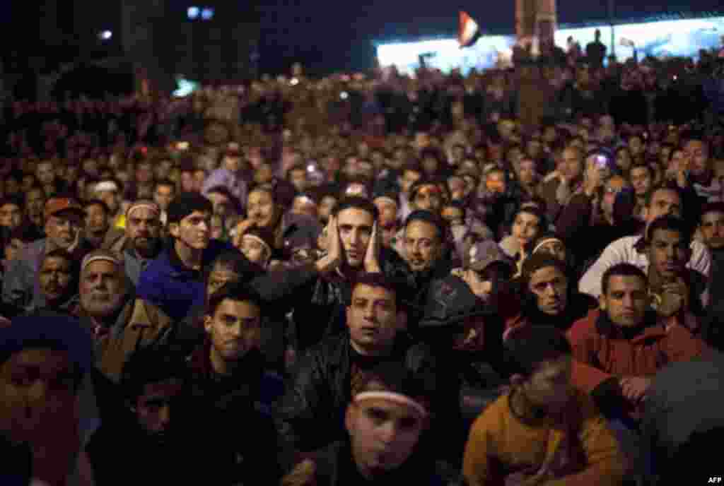 Anti-government protesters watch on big screen as Egyptian President Hosni Mubarak makes a televised statement to his nation in Tahrir Square in downtown Cairo, Egypt Thursday, Feb. 10, 2011. Egyptian President Hosni Mubarak announced he is handing his po