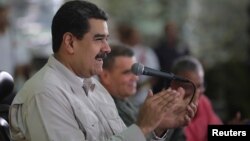 FILE - Venezuela's President Nicolas Maduro attends an event with workers in Caracas, Nov. 14, 2017.