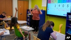 Elementary math teacher Margie Howells teaches a fifth-grade class at Wheeling Country Day School in Wheeling, WV, on Tuesday, Sept. 5, 2023. (AP Photo/Gene J. Puskar)