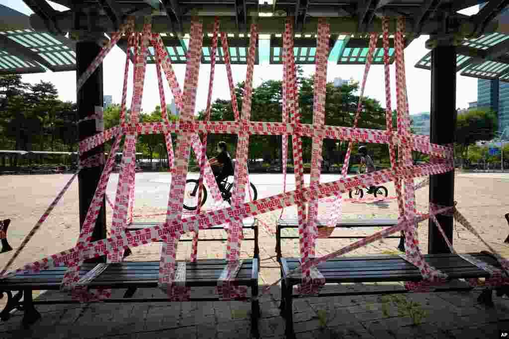 Public benches are taped off according to social distancing rules at a park in Anyang, South Korea.