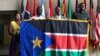 From left, Regina Onyeibe, Africa liaison for Dallas, Dallas-area resident Michael Majok, Dallas City Councilman Dwaine Caraway and pro basketball star Luol Deng participate in the raising of the South Sudanese flag at City Hall in Dallas, Texas, July 2017.