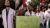 Medical workers from Princess Alia Governmental Hospital and other protesters gather for a demonstration condemning the targeting of hospitals and medical clinics and in solidarity with Palestinians in the Gaza Strip, in the city of Hebron in the occupied