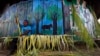 FILE - A Sarayaku Indian man creates decorations out of palms in the village of Sarayaku in Ecuador.