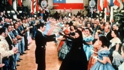 Clark Gable and Vivien Leigh play Rhett Butler and Scarlett O'Hara, center, in the 1939 movie "Gone With the Wind"