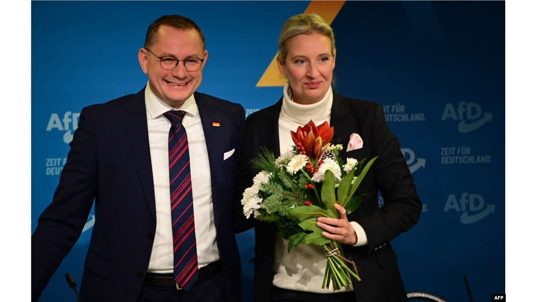 FILE - Alice Weidel, co-leader of Germany's far-right Alternative for Germany party, holds a bouquet of flowers she was given by party co-leader Tino Chrupalla during a press conference on Dec. 7, 2024, in Berlin.