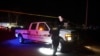 Archivo - El vehículo de un alguacil es conducido bajo cinta policial cerca de la escena de un tiroteo el lunes 2 de enero de 2019.