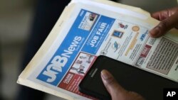 FILE - An applicant attends a job fair in Miami Lakes, Florida. 