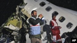 In this picture released by the Mehr news agency, rescue workers attend the scene after an IranAir passenger plane crashed as it was making an emergency landing, outside the city of Orumiyeh, Iran, Sunday, Jan. 9, 2011.