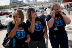 From left, Linda Hazelwood, Michelle Hamel and Jann Blake, all from California, cry as they attend a prayer service on the anniversary of the Oct. 1, 2017 mass shooting in Las Vegas, Oct. 1, 2018.