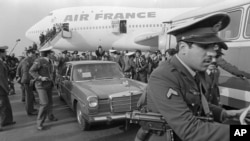  In this Feb. 1, 1979 file photo, Ayatollah Ruhollah Khomeini has a heavy escort as he enters car to leave the airport in Tehran, Iran. Friday, Feb. 1, 2019, marks the 40th anniversary of Khomeini's descent from the chartered Air France Boeing 747.