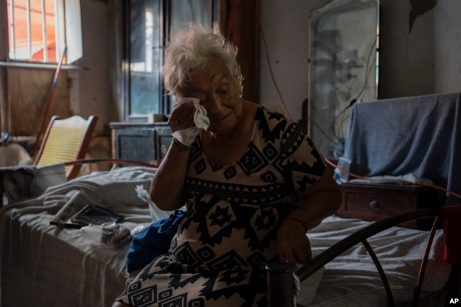 In this file photo, Margarita Salazar, 82, wipes the sweat off with a tissue inside her home in Veracruz, Mexico on June 16, 2024. (AP Photo/Felix Marquez, File)