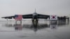 National flags of the US and South Korea are displayed in front of a B-52H strategic bomber parked at a South Korean Air Force base at Cheongju Airport on Oct. 19, 2023.