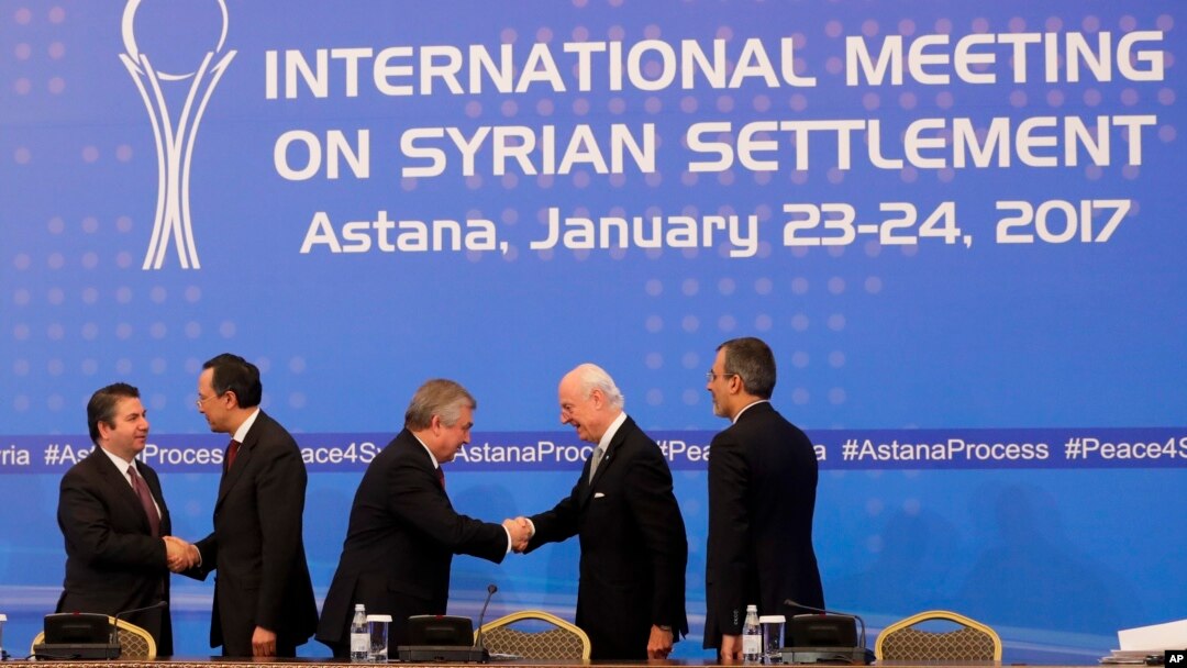 FILE - Participants shake hands after final statement following talks on Syrian peace in Astana, Kazakhstan, Jan. 24, 2017. 