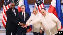 From left, U.S. Defense Secretary Lloyd Austin, Secretary of State Antony Blinken, Philippine Foreign Secretary Enrique Manalo and National Defense Secretary Gilberto Teodoro pose for the press at Camp Aguinaldo in Manila, Philippines, July 30, 2024.