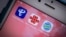 资料照片：iPhone上中国三大移动通信运营商--中国电信、中国联通和中国移动的图标。(2021年3月10日)
