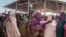 FILE - Women gather for a food distribution at the Farbudo internally displaced person camp, in Gode, near Kebri Dahar, southeastern Ethiopia, Jan. 27, 2018.