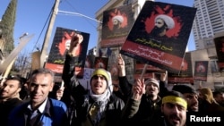 Iranian protesters chant slogans as they hold pictures of Shi'ite cleric Sheikh Nimr al-Nimr during a demonstration against the execution of Nimr in Saudi Arabia, outside the Saudi Arabian Embassy in Tehran Jan. 3, 2016