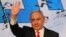 Israeli Prime Minister Benjamin Netanyahu gestures as he delivers a speech to supporters following the announcement of exit polls in Israel's general election at his Likud party headquarters in Jerusalem, March 24, 2021.