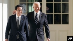 FILE - President Joe Biden and Japanese Prime Minister Fumio Kishida walk at the White House, Jan. 13, 2023. Biden will host Kishida on April 10, with the goal of strengthening a critical alliance as the U.S. has sought to counter China's influence in the Indo Pacific region. 