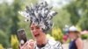 Britain&#39;s Queen Elizabeth II (L) watches as Italian jockey Frankie Dettori (R)&nbsp;celebrates with the trophy after he won the Gold Cup on horse Stradivarius, his fourth win of the day, on day three of the Royal Ascot horse racing meet, in Ascot, west of London.