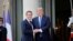 French President Emmanuel Macron greets U.S. President Donald Trump 