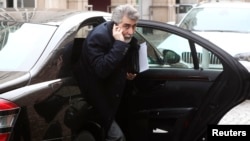 Iran's ambassador to Austria Hassan Tajik leaves his limousine as he arrives at a hotel in Vienna, Feb. 17, 2014.