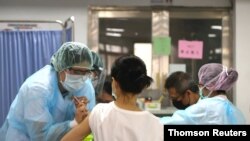 A nurse administers a dose of the AstraZeneca vaccine against the coronavirus disease (COVID-19) during a vaccination session for health care workers in Taipei, Taiwan, June 2, 2021. 