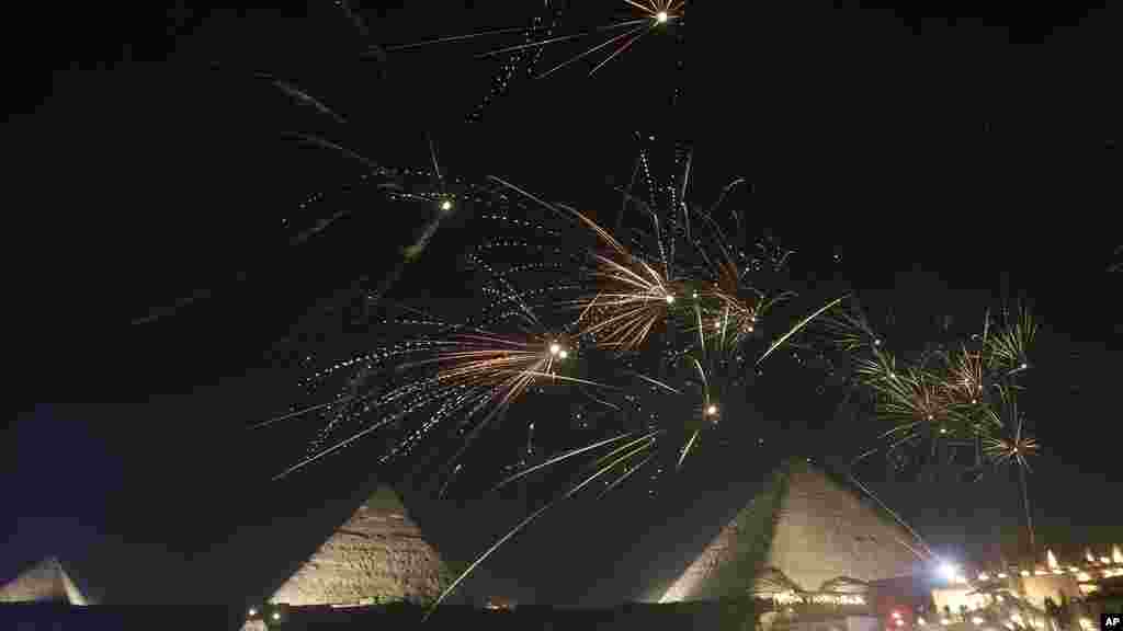 Fireworks spark over the Giza Pyramids, marking the new year, just outside Cairo, Egypt, Jan. 1, 2025. 