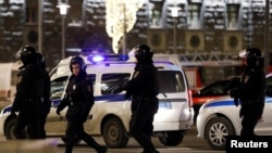 Police officers are seen near the Federal Security Service building after a shooting, in Moscow, Russia, Dec. 19, 2019. 