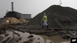 Outside the 25-year-old containment shell for the Chernobyl nuclear power plant, workers start construction of a new $2 billion cover that is to seal 200 tons of radioactive material for another century.