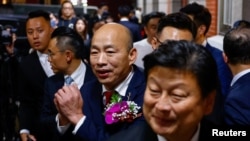 Han Kuo-yu, center, the newly elected legislative speaker from Taiwan's largest opposition party, the Kuomintang, greets the media in Taipei on Feb. 1, 2024.