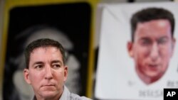 Journalist Glenn Greenwald listens to a question during a press conference before the start of a protest in his support in front of the headquarters of the Brazilian Press Association, known as ABI, in the city of Rio de Janeiro, Brazil, July 30 , 2019. 