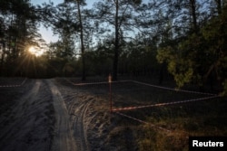 Tape warns of mines in the Sviati Hory National Nature Park, Donetsk region, amid Russia's attack on Ukraine, July 26, 2024. Authorities say they still need to inspect 3 million hectares of forest that are likely riddled with mines and ordnance.