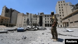 A Syria Democratic Forces (SDF) fighter walks in the silos and mills of Manbij after the SDF took control of it, in Aleppo Governorate, Syria, July 1, 2016.