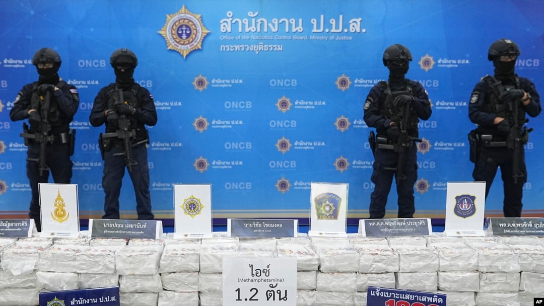 FILE - Police officers stand behind seized crystal methamphetamine during a news conference in Bangkok, Thailand, May 29, 2023. Law enforcement officials said they seized more than a ton of crystal methamphetamine that they believed was bound for Australia.