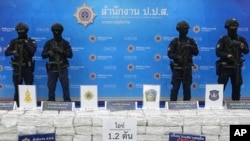 FILE - Police officers stand behind seized crystal methamphetamine during a news conference in Bangkok, Thailand, May 29, 2023. Law enforcement officials said they seized more than a ton of crystal methamphetamine that they believed was bound for Australia.
