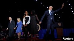 President Barack Obama (R) is joined onstage by first lady Michelle Obama and daughter Malia, Vice President Joe Biden and his wife Jill Biden, after his farewell address in Chicago, Illinois, Jan. 10, 2017. 