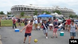 US Team fans kick around soccer ball before the US-Germany game at RFK stadium in Washington, D.C., June 2, 2013. (Photo: Parke Brewer / VOA)