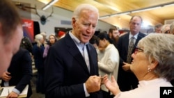 Democratic presidential candidate former Vice President Joe Biden talks with audience members during a bus tour stop at Water's Edge Nature Center, Dec. 2, 2019, in Algona, Iowa.