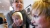 Melissa Rayworth reacts after getting a haircut from Laurent D., left, as she undergoes a makeover at his salon Prive in New York, April 22, 2005. (AP Photo/Bebeto Matthews)