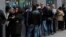 People wait outside unemployment office in Madrid, Spain, April 2, 2013.