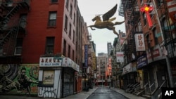 A street in New York's Chinatown is empty, the result of citywide restrictions calling for people to stay indoors and maintain social distancing in an effort to curb the spread of COVID-19, March 28, 2020, in New York.