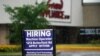 FILE - A hiring sign is displayed in Downers Grove, Ill., June 24, 2021. 