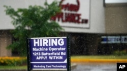 FILE - A hiring sign is displayed in Downers Grove, Ill., June 24, 2021. 