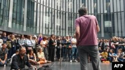FILE - Workers of the French state owned radio group Radio France attend a general assembly at the group's headquarters "Maison de la Radio" on June 18, 2019 in Paris, during a strike to protest against a new budget plan of 300 job cuts. 