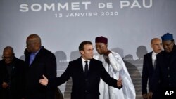 FILE - French President Emmanuel Macron, center, is pictured with G5 African heads of state after the G5 Sahel summit in Pau, France, Jan.13, 2020.