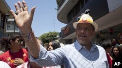 Luis Guillermo Solis, presidential candidate of the Citizen's Action Party waves during a campaign rally in San Jose, Costa Rica, Friday, April 4, 2014.