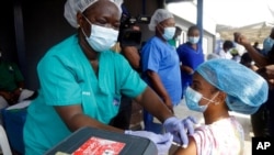 Hospital staff receives one of the country's first coronavirus vaccinations using AstraZeneca vaccine manufactured by the Serum Institute of India and provided through the global COVAX initiative, at Yaba Mainland hospital in Lagos, March 12, 2021.