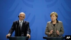 German Chancellor Angela Merkel, right, and the President of Afghanistan, Ashraf Ghani brief the media after a meeting at the chancellery in Berlin, Dec. 2, 2015. 